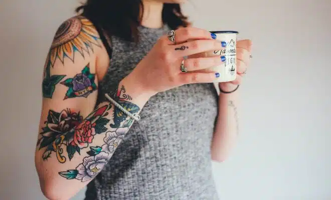 woman holding white ceramic mug